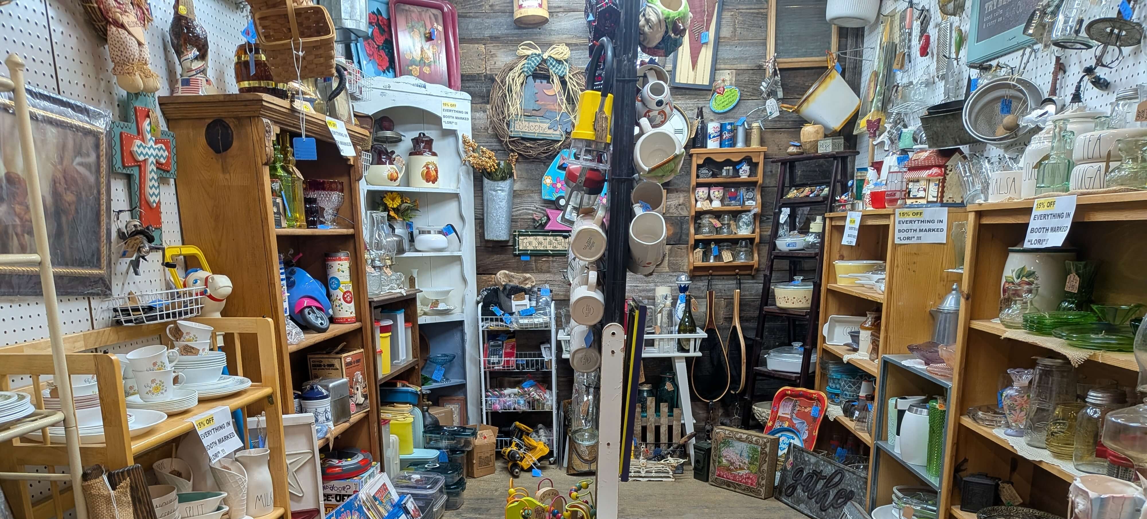 Crowded reseller booth filled with inventory on shelves